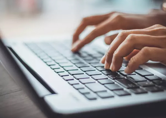 Hands on a laptop keyboard